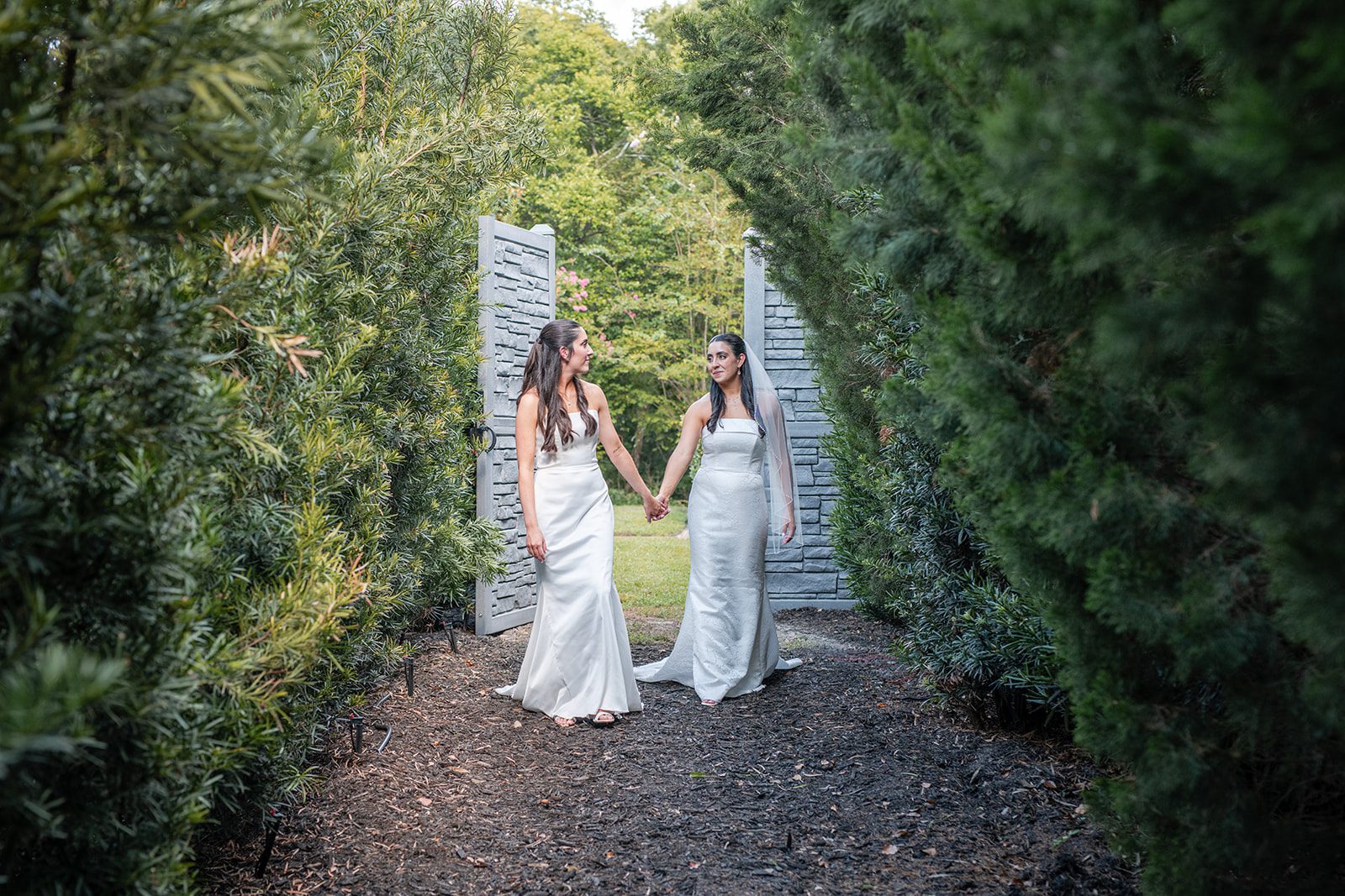 villa-festa-timeless-orlando-alondra-madison-023-06 Brides walking along the garden path, captured by Orlando wedding photographers from Original Weddings at Villa Festa