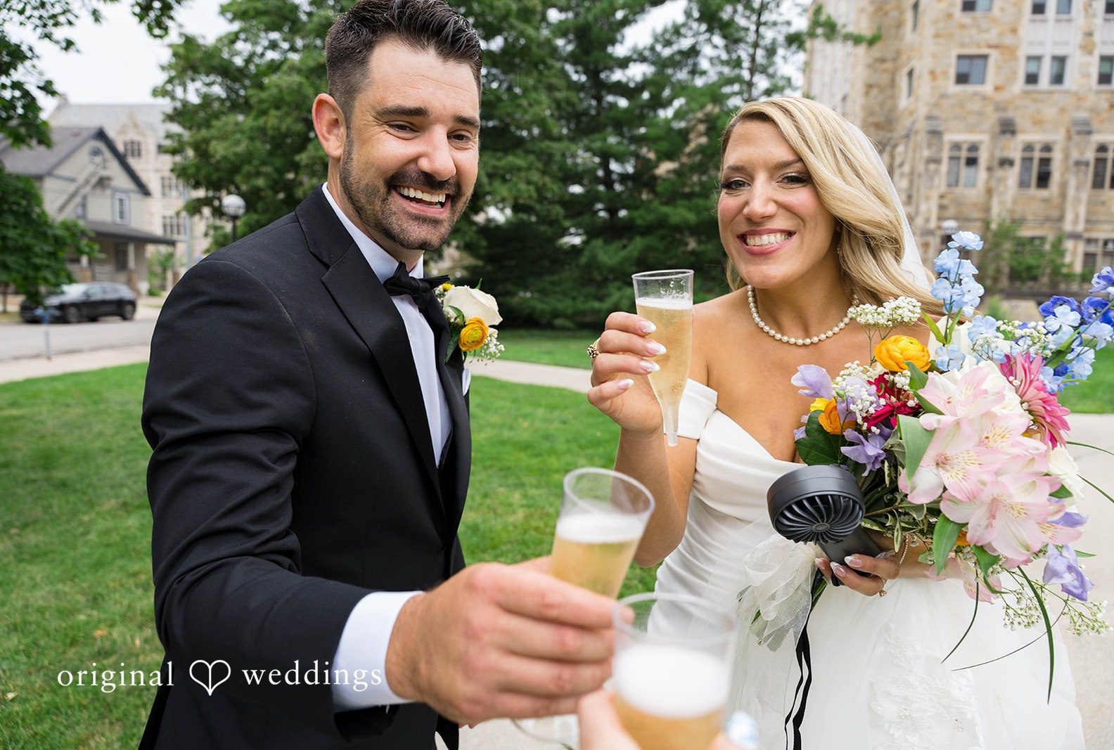 Bride and groom toasting outdoors, captured by Detroit wedding photographers from Original Weddings at Vinology