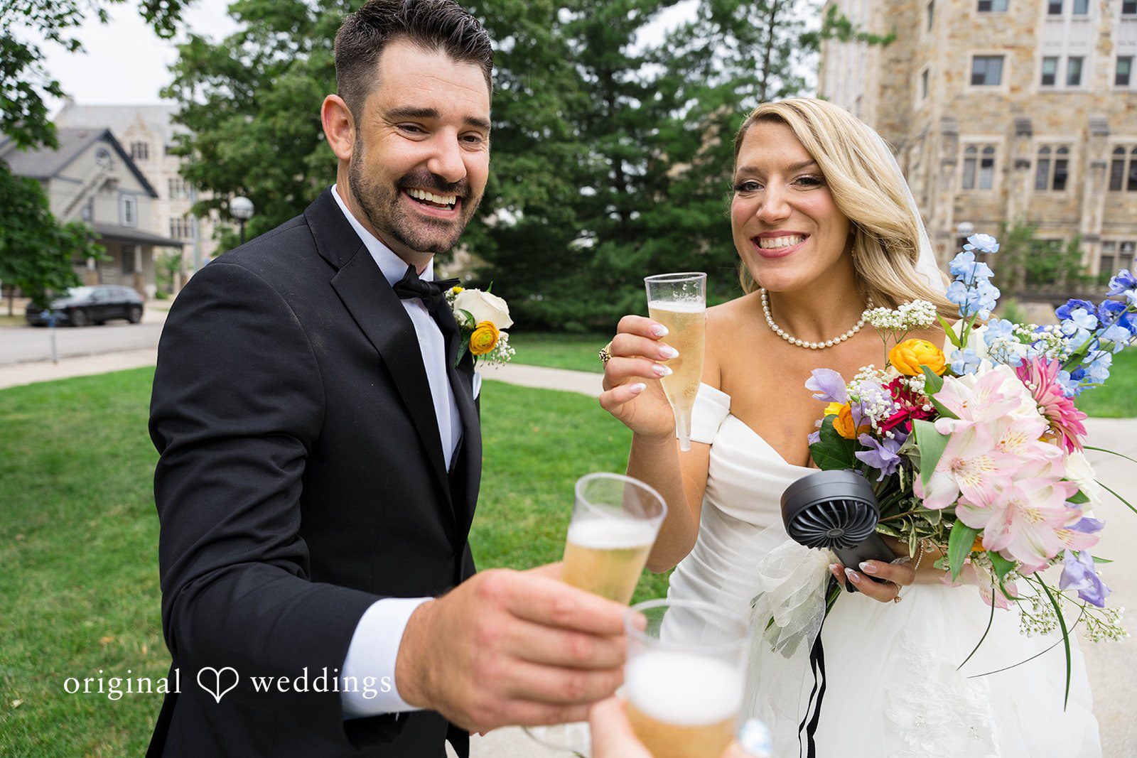 Bride and groom toasting outdoors, captured by Detroit wedding photographers from Original Weddings at Vinology