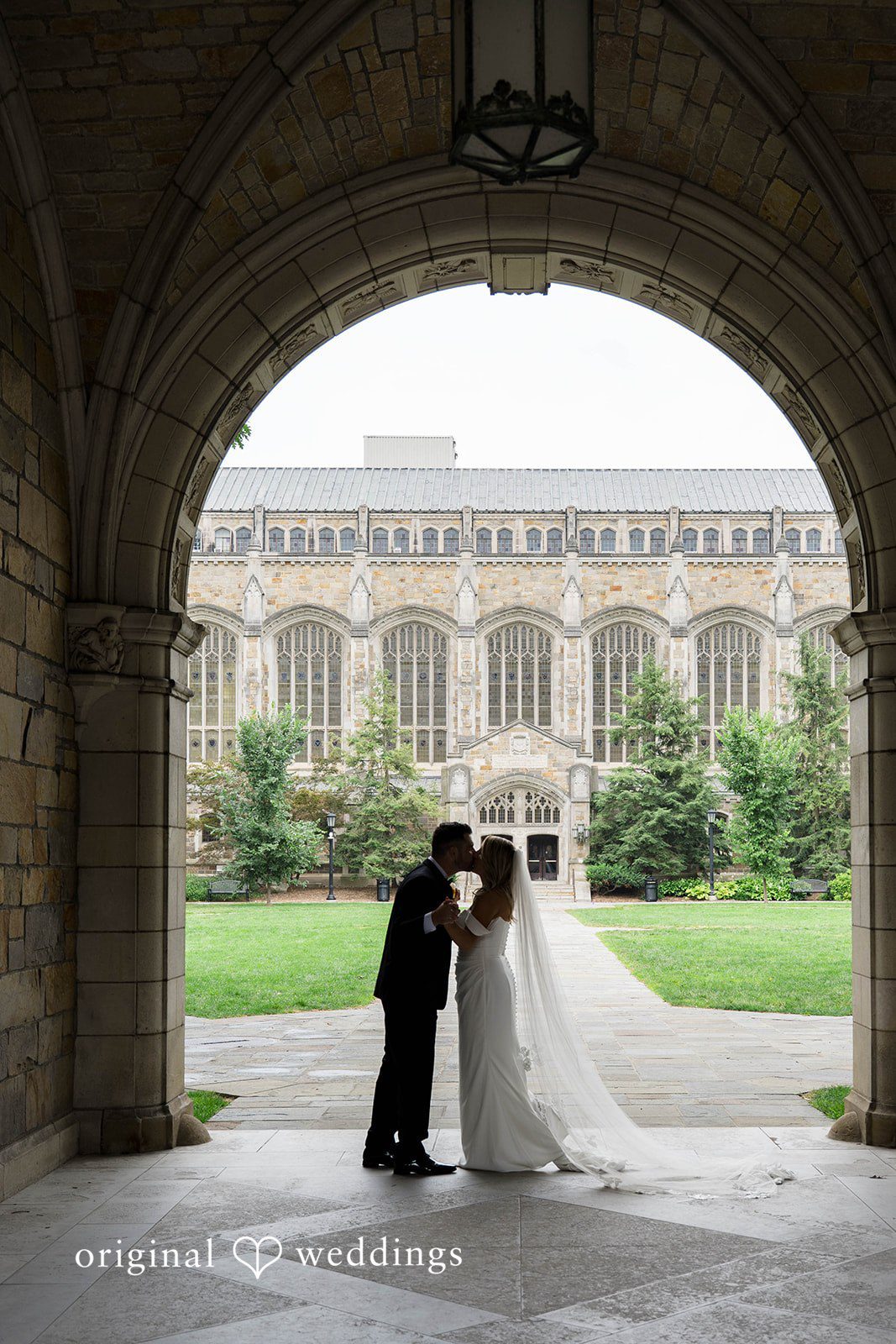 Couple framed by a stone archway on their Vinology wedding day