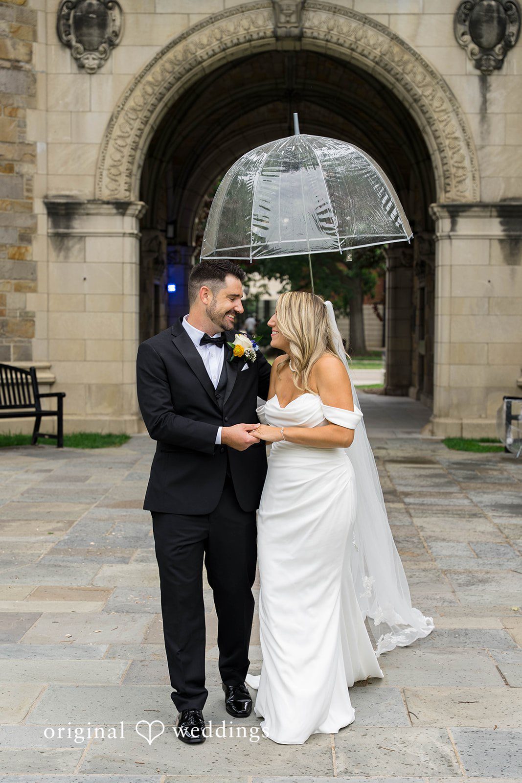Andrew and Nicole embracing under an umbrella on their Vinology wedding day