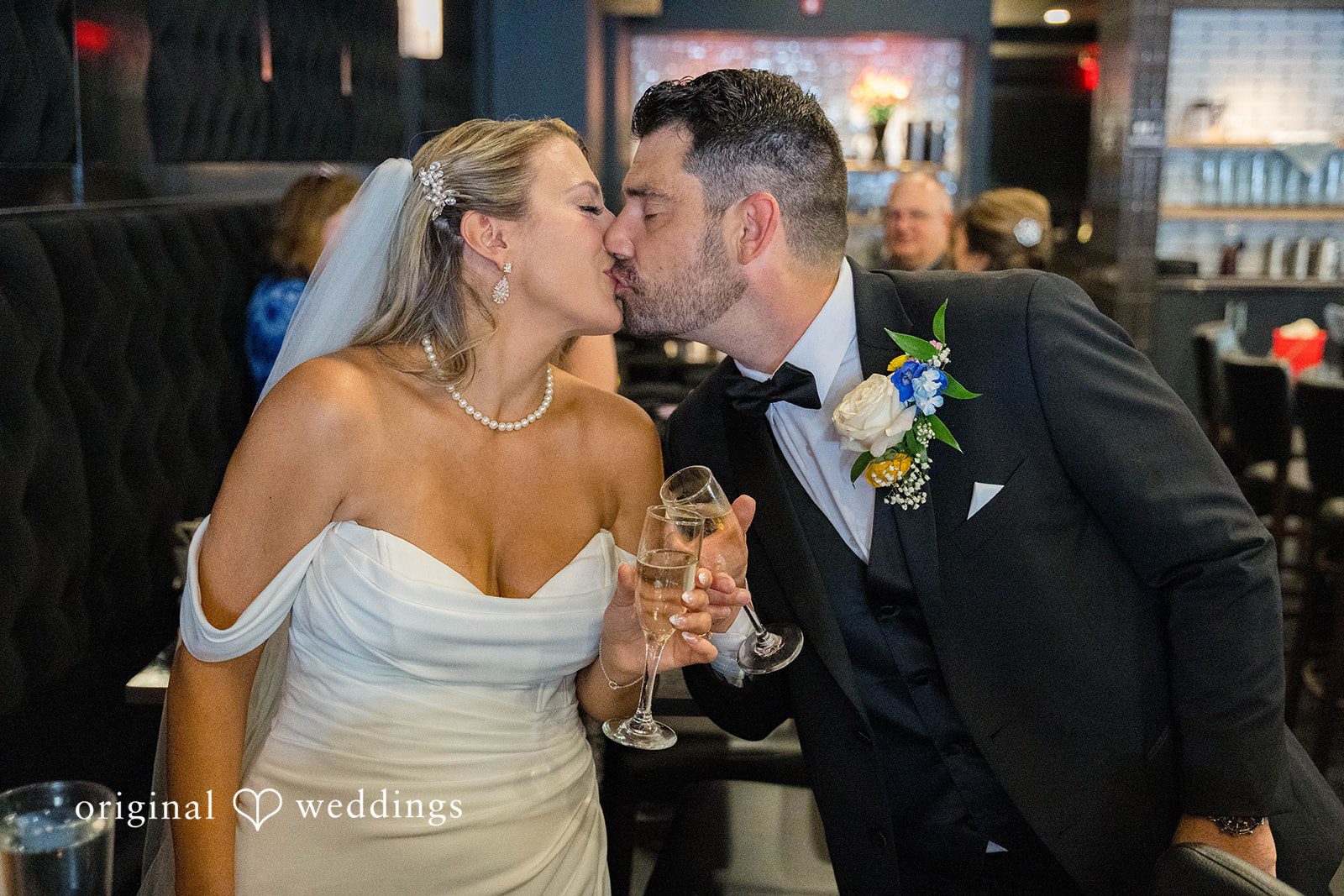 Couple sharing a kiss at the Vinology wedding reception