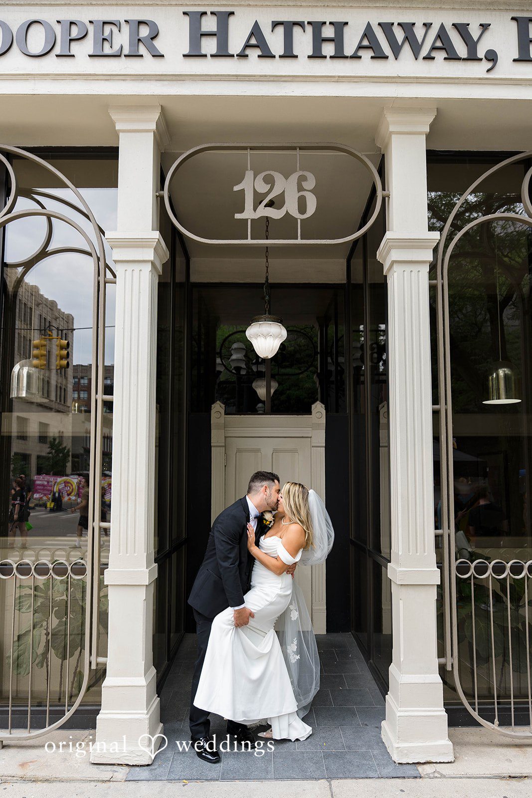 Andrew and Nicole in a city doorway on their Vinology wedding day
