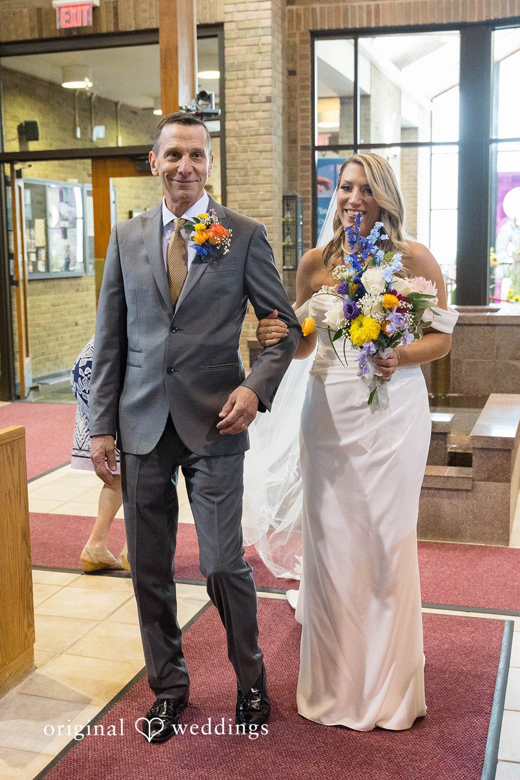 Newlyweds walking up the aisle on their Vinology wedding day