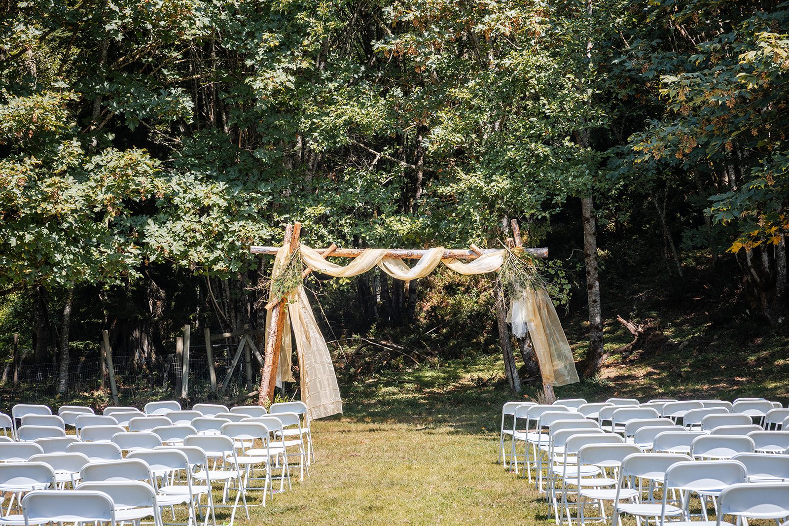washington-backyard-timeless-seattle-beth-gunner-p002-06 Rustic ceremony arch draped with fabric at a Washington backyard wedding