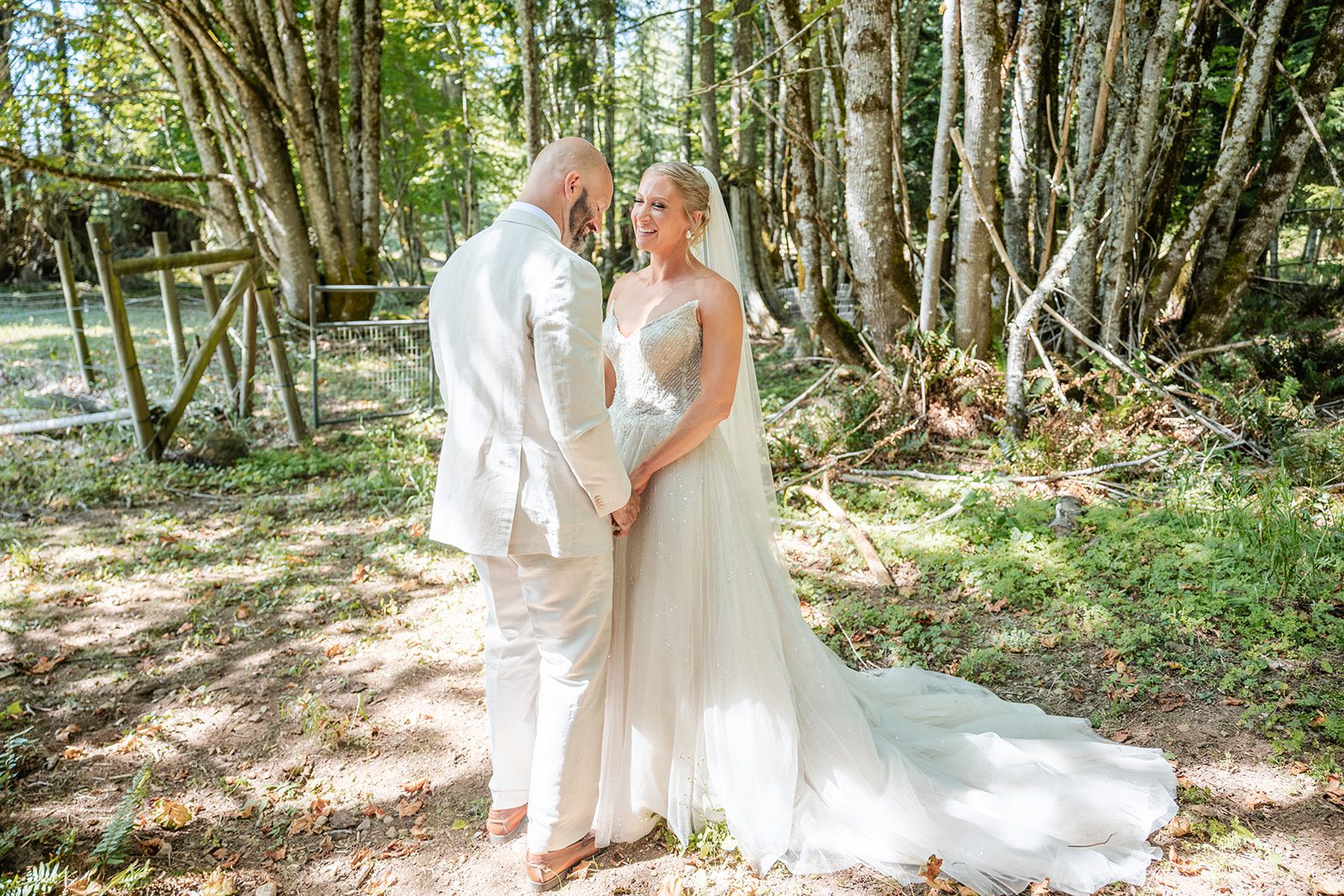 washington-backyard-timeless-seattle-beth-gunner-p018-19 Bride and groom smiling in the forest, captured by Seattle wedding photographers from Original Weddings at a Washington backyard wedding