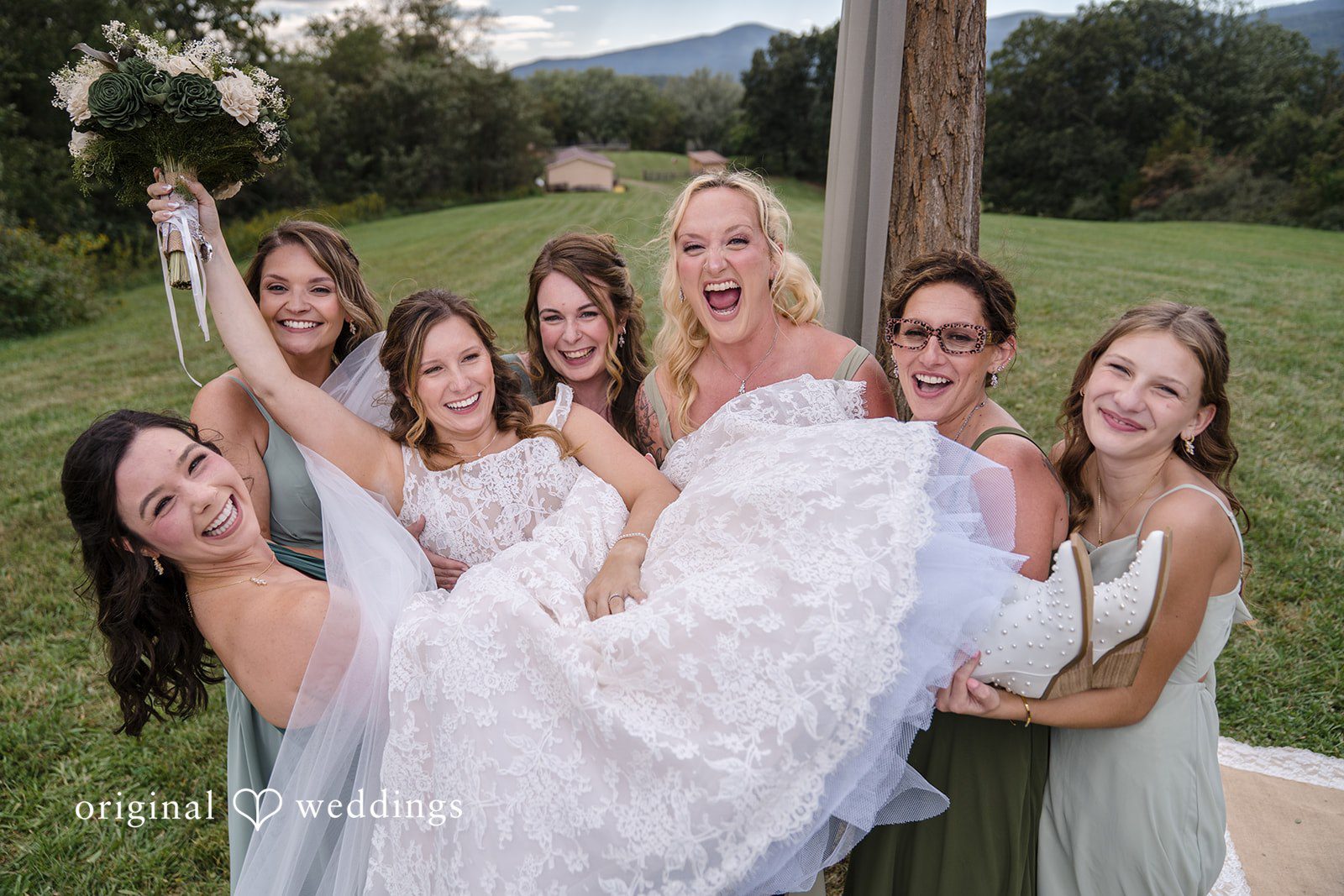 Shelby + Eli The bridesmaids lift the bride in excitement