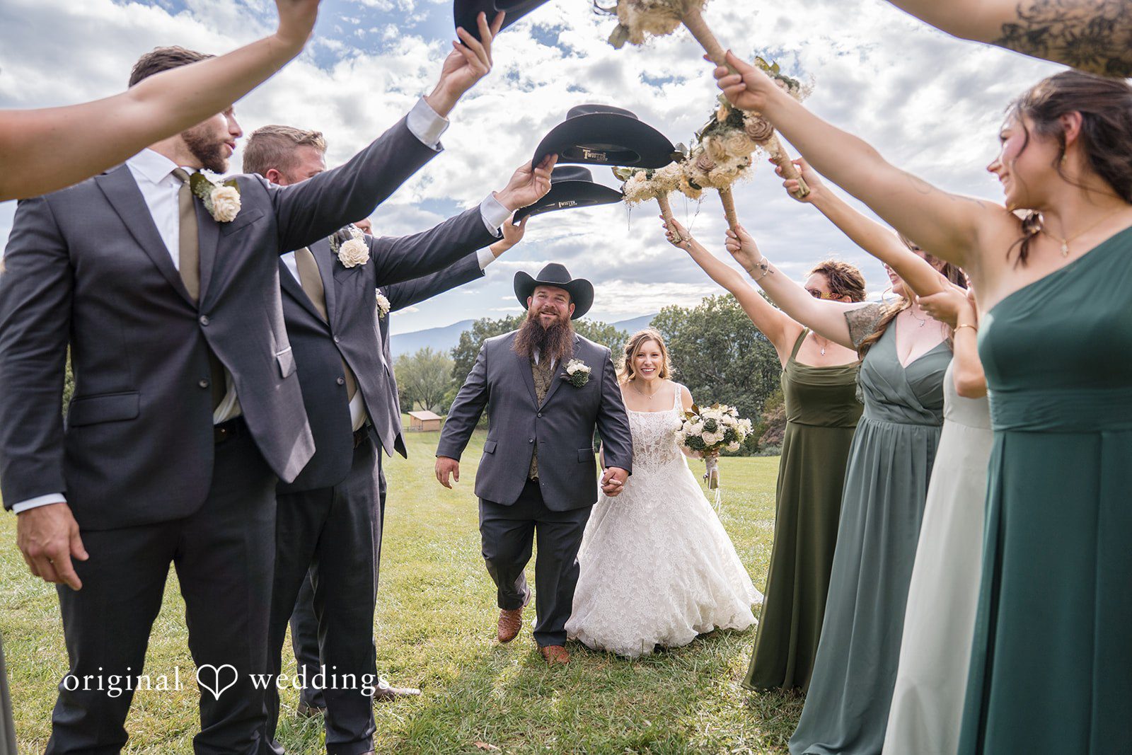 Shelby + Eli The couple passes through a tunnel of cheering guests