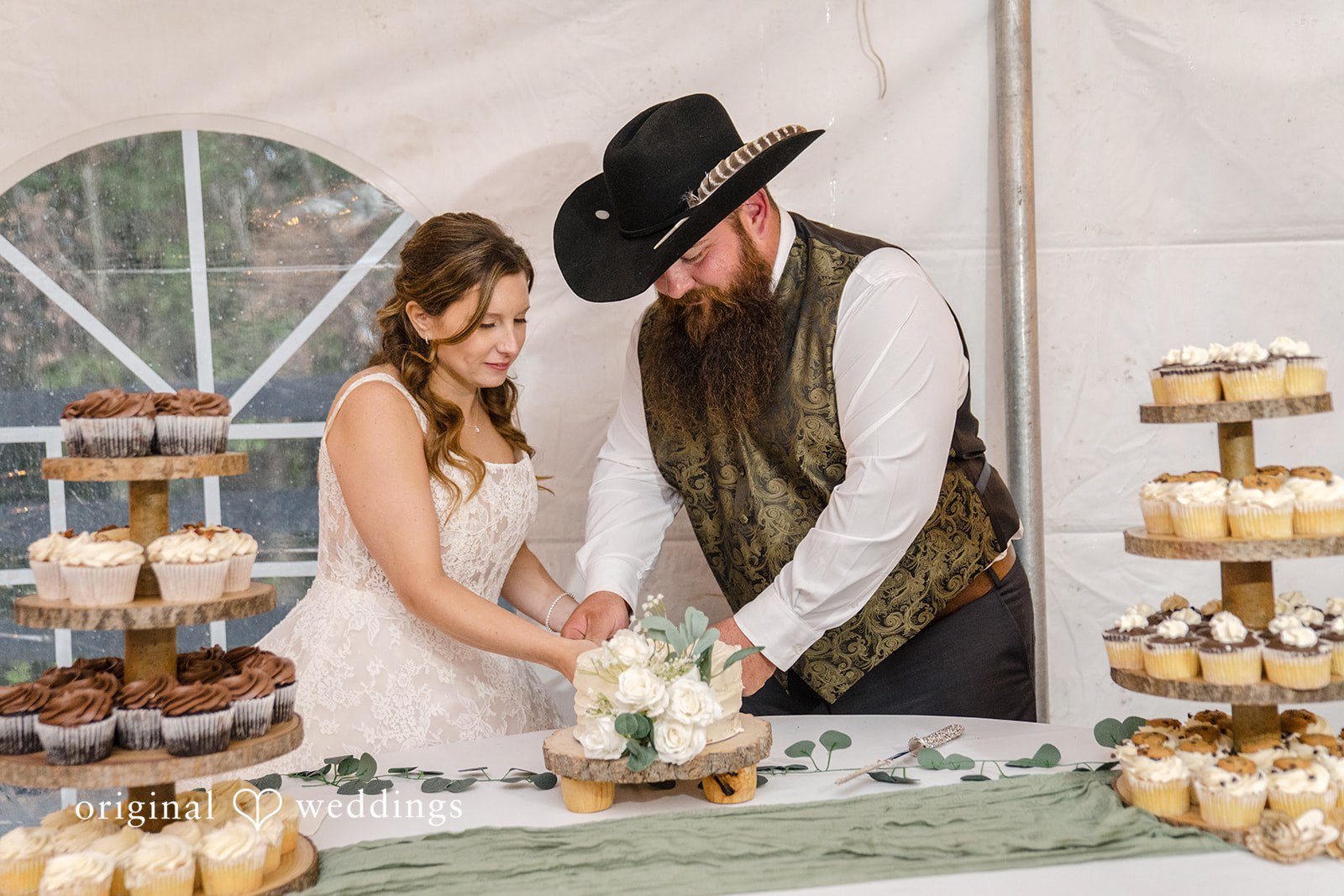 Shelby + Eli The couple cuts their wedding cake