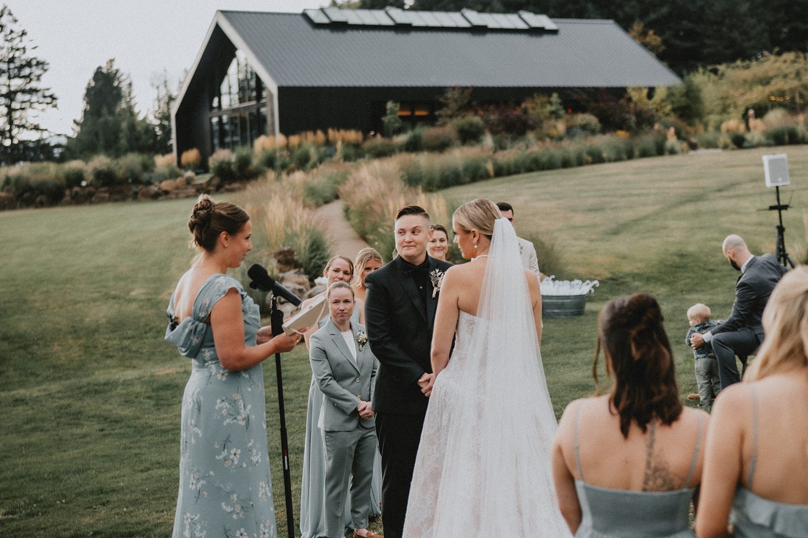 wind-mountain-ranch-rustic-portland-cj-rachel-p014-03 Guests watching the ceremony on the lawn