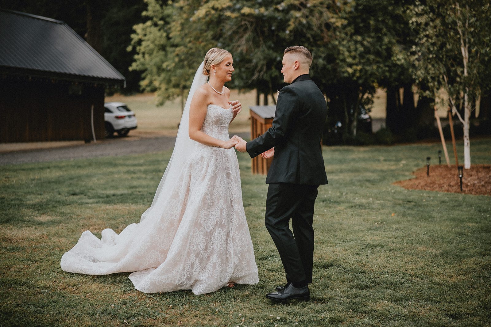 wind-mountain-ranch-rustic-portland-cj-rachel-p017-06 Couple holding hands on the lawn
