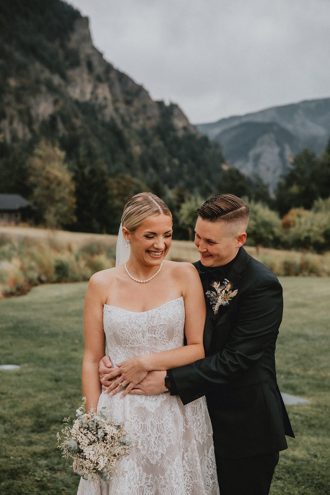 wind-mountain-ranch-rustic-portland-cj-rachel-p023-10 Couple laughing together by the trees