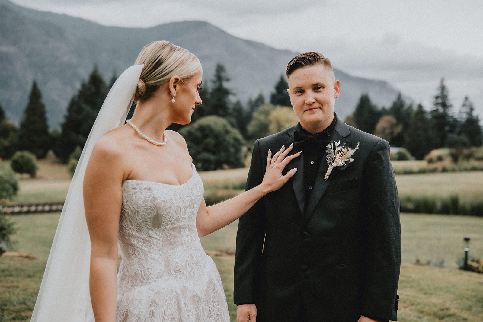 wind-mountain-ranch-rustic-portland-cj-rachel-p025-08 Couple smiling together with mountain views, captured by Portland wedding photographers from Original Weddings at Wind Mountain Ranch