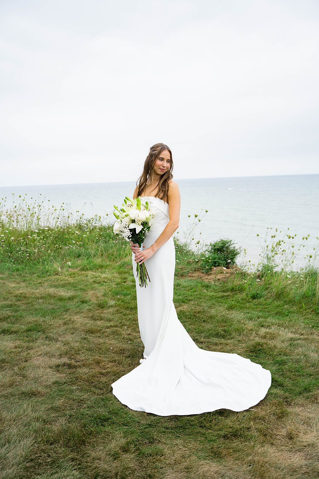 Bride in her gown by the water