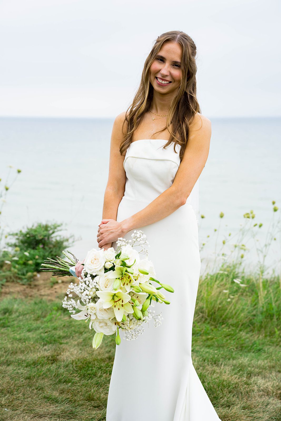 Bride holding her bouquet in the backyard