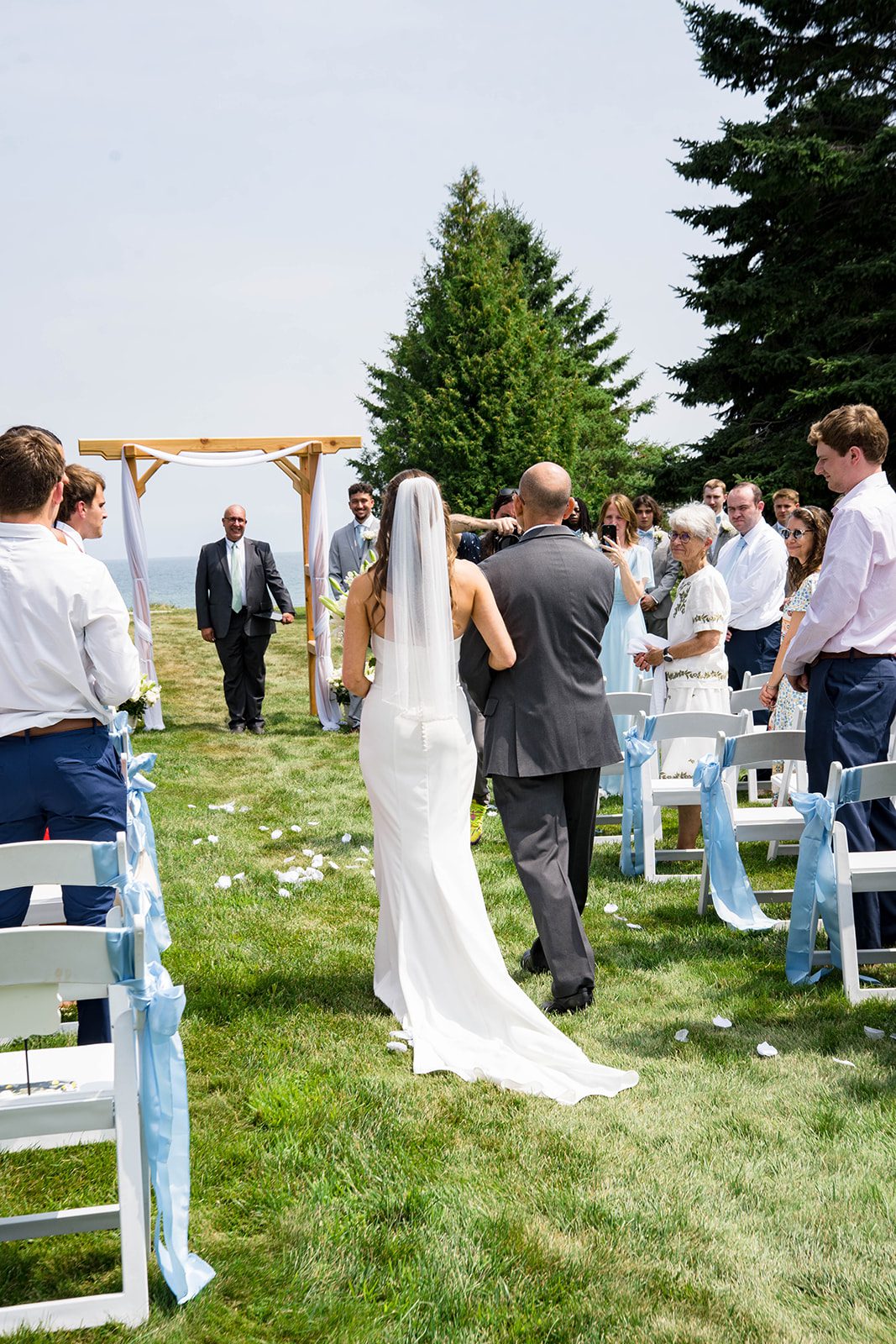 Guests watching the bride walk down the aisle