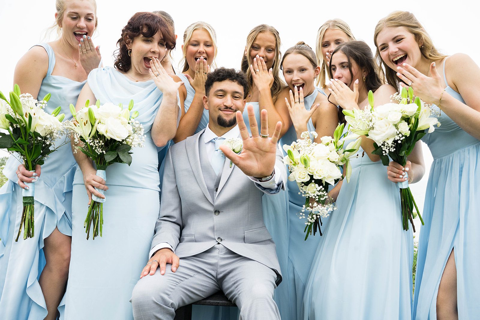 Wedding party cheering with the couple