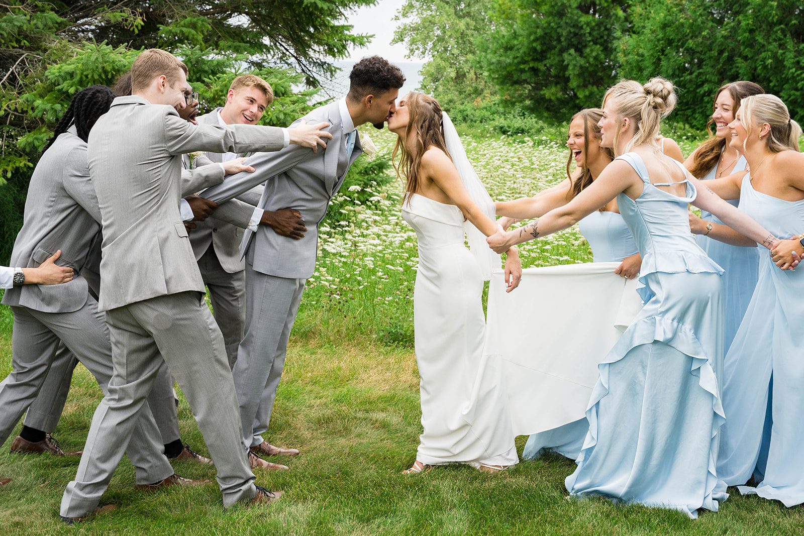 Groomsmen and bridesmaids having fun on the lawn