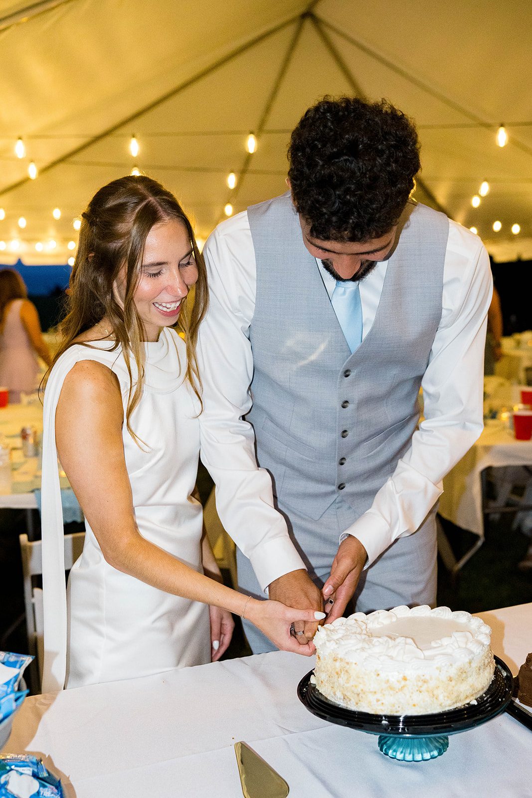 Couple cutting their wedding cake