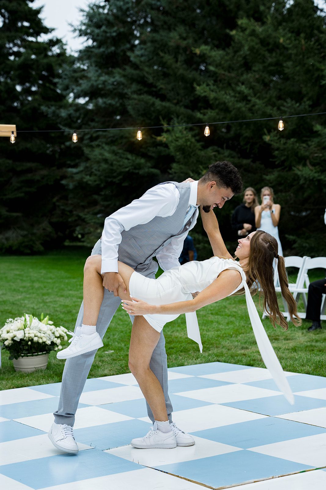 Bride and groom dancing outdoors