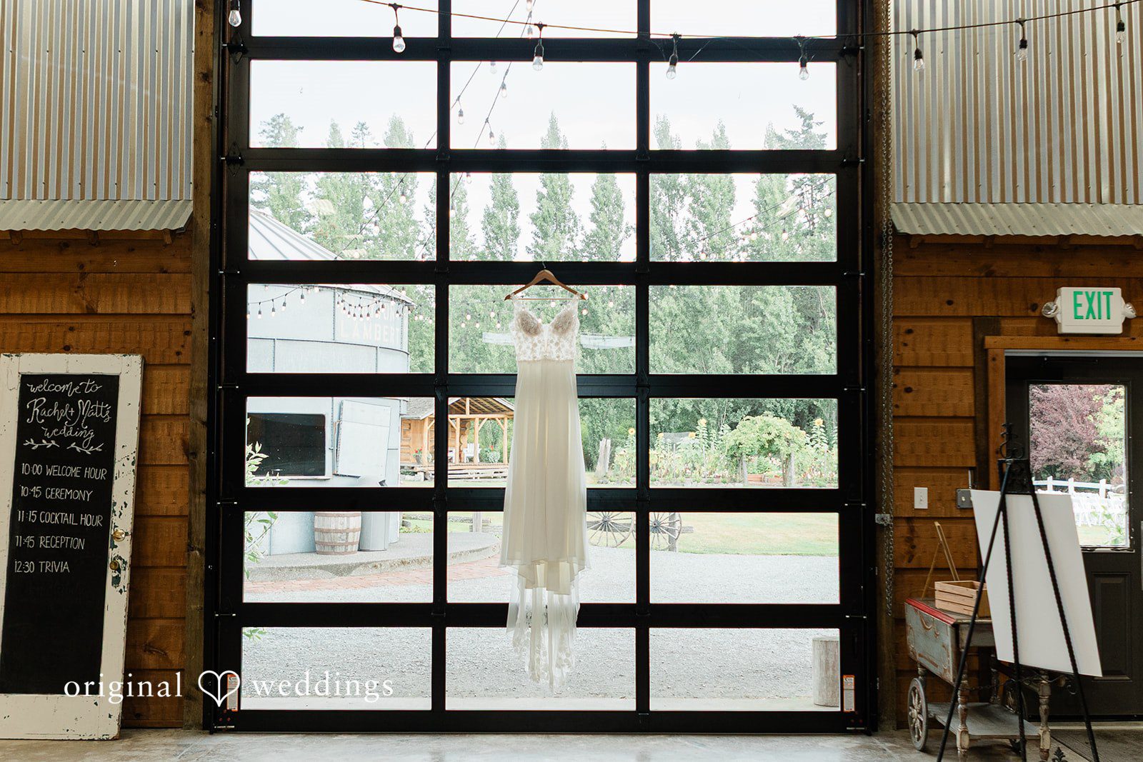 Rachel + Matt Rachel's wedding dress hanging in the barn doorway