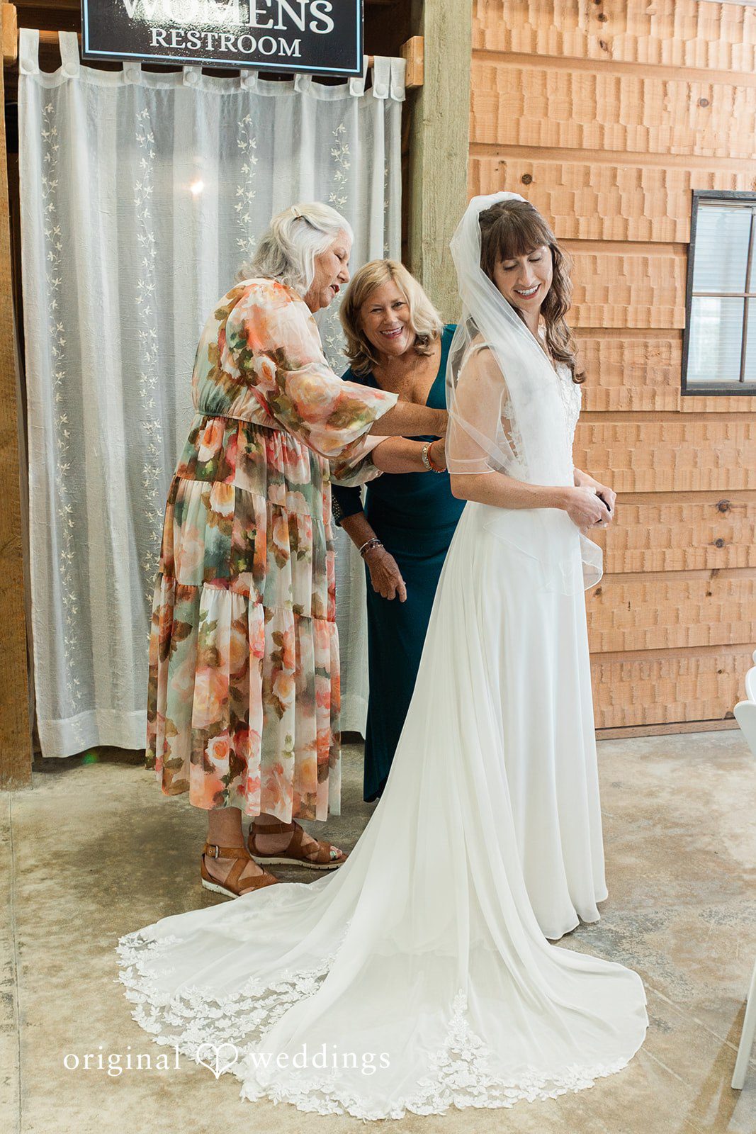 Rachel + Matt Bride getting zipped into her gown