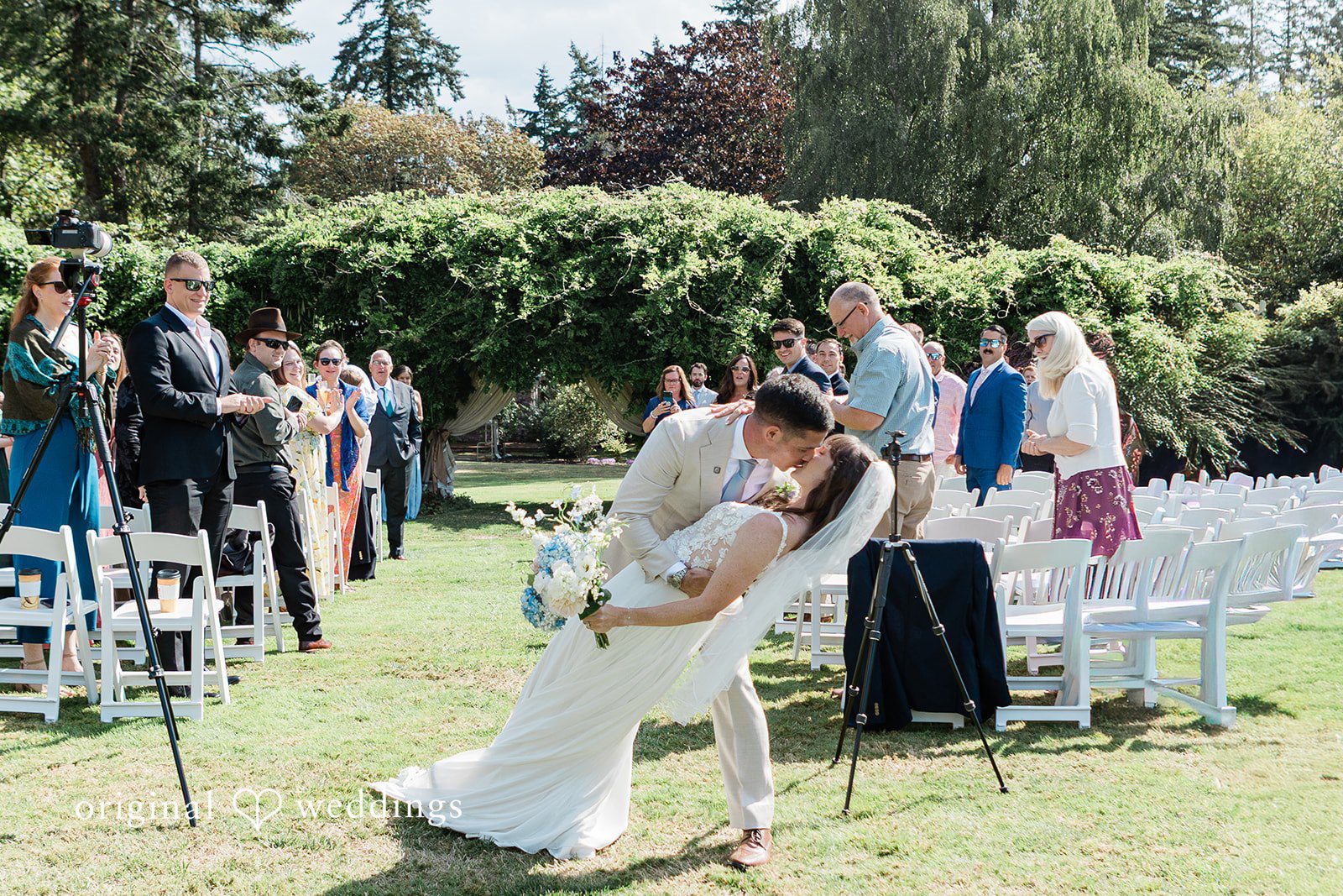 Rachel + Matt Dip kiss on the aisle after the ceremony at Wisteria Gardens
