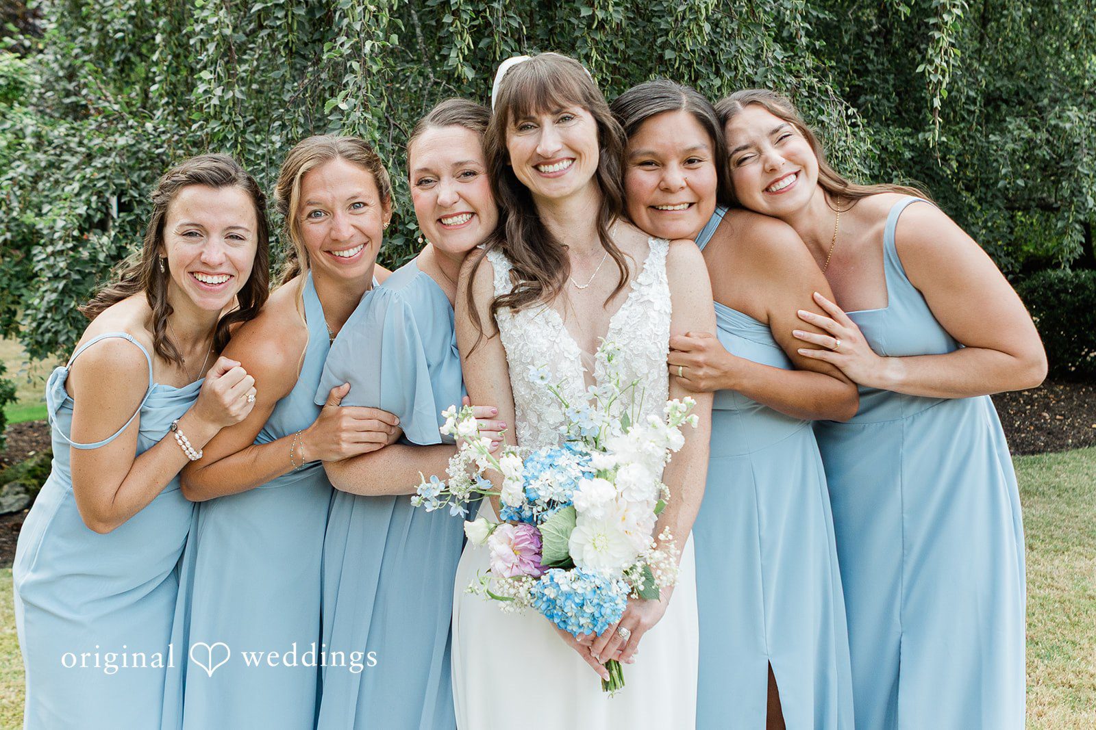 Rachel + Matt Bride laughing with her bridesmaids in blue
