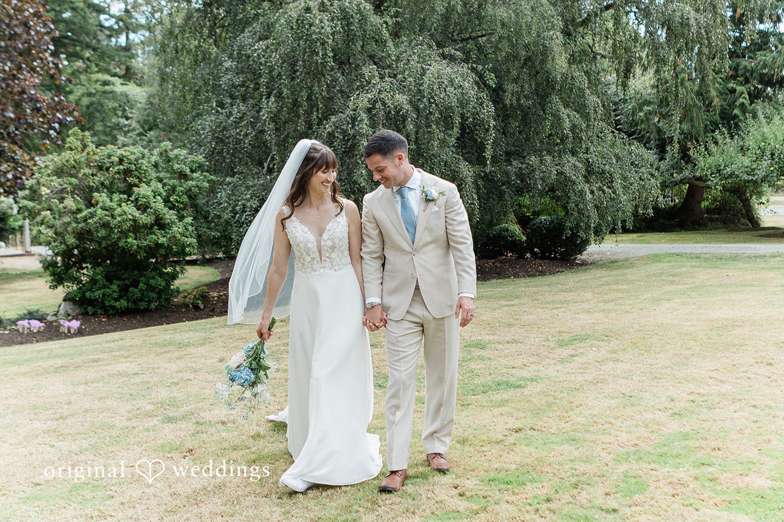 Rachel + Matt Bride and groom walking across the lawn, captured by Seattle wedding photographers from Original Weddings