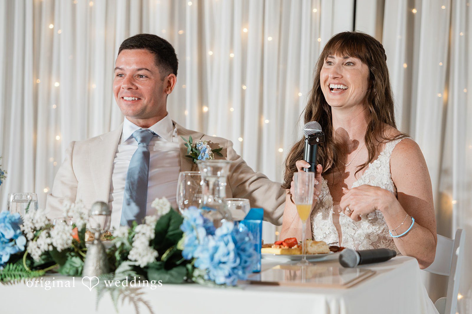 Rachel + Matt Couple laughing at the sweetheart table