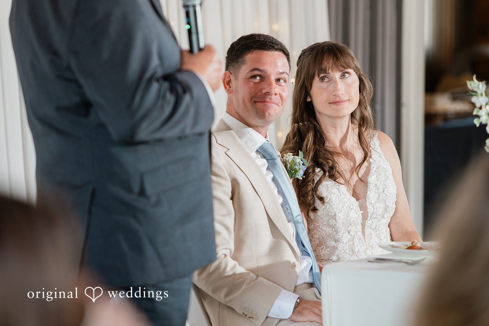 Rachel + Matt Couple listening to toasts at the reception