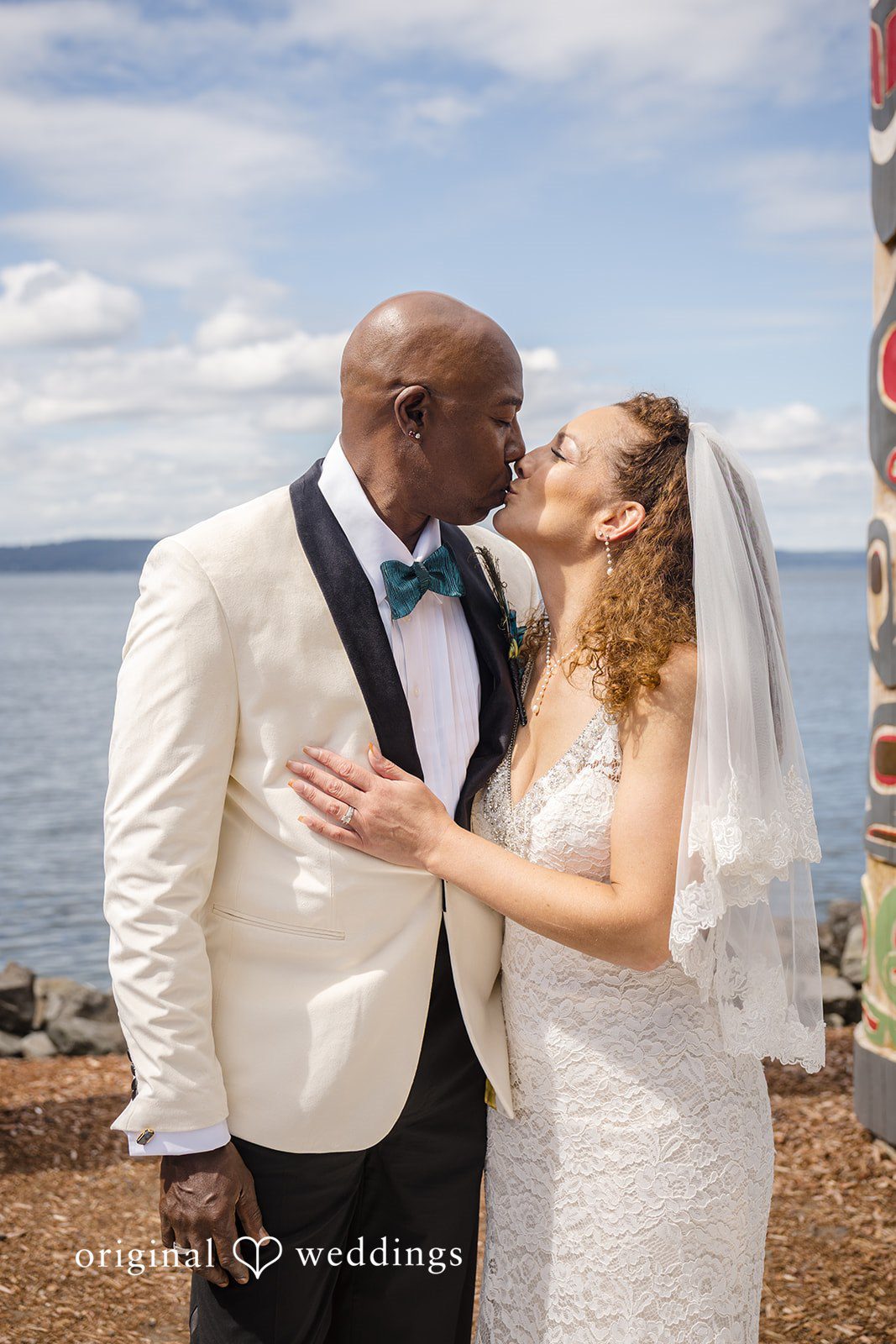 Jennifer + Tony A bride and groom embracing and sharing a kiss after getting married.