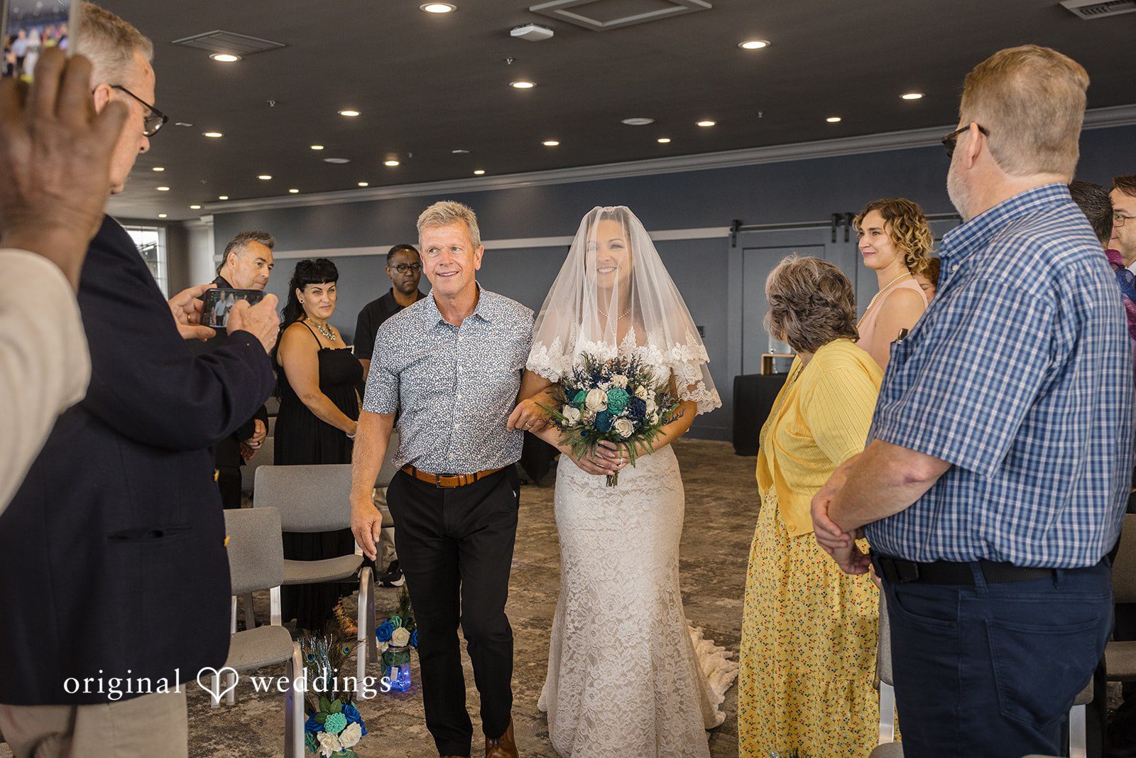 Jennifer + Tony Bride walking down an aisle with a man.