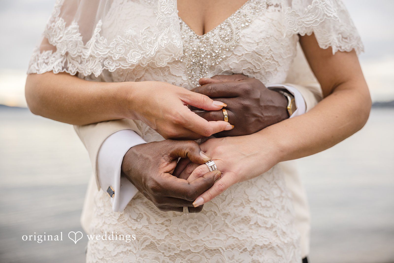 Jennifer + Tony A close-up shot of a person's hands holding and showing rings.