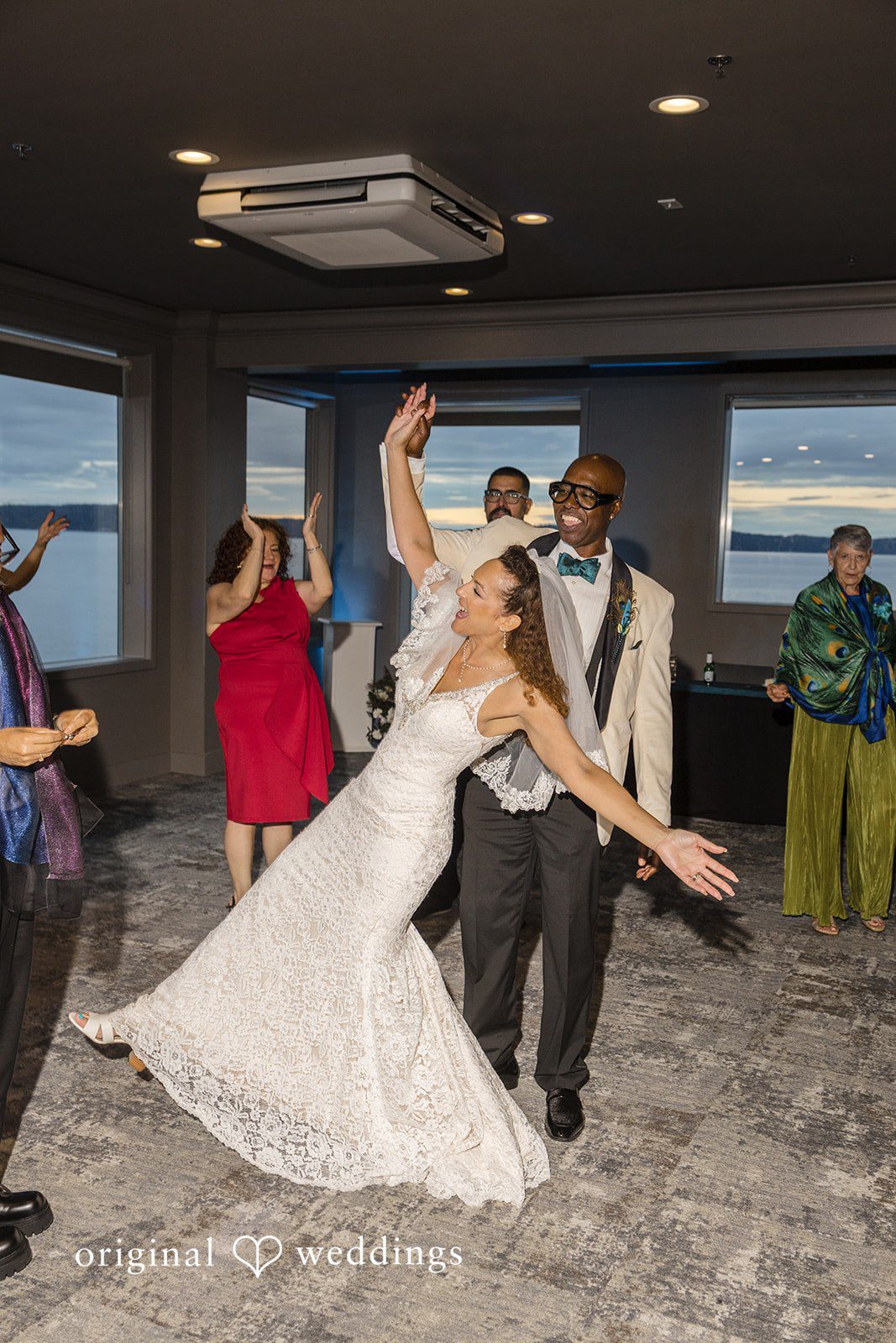 Jennifer + Tony A groom dipping his bride while dancing dramatically on a crowded dance floor.